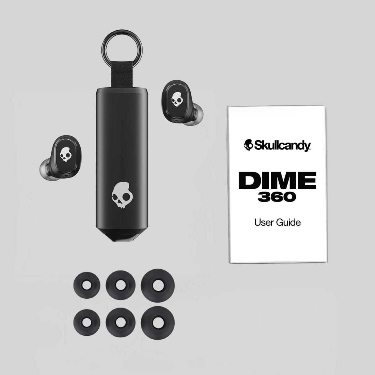 Skullcandy Dime 360 earbuds with case and user guide on a gray background | Bone