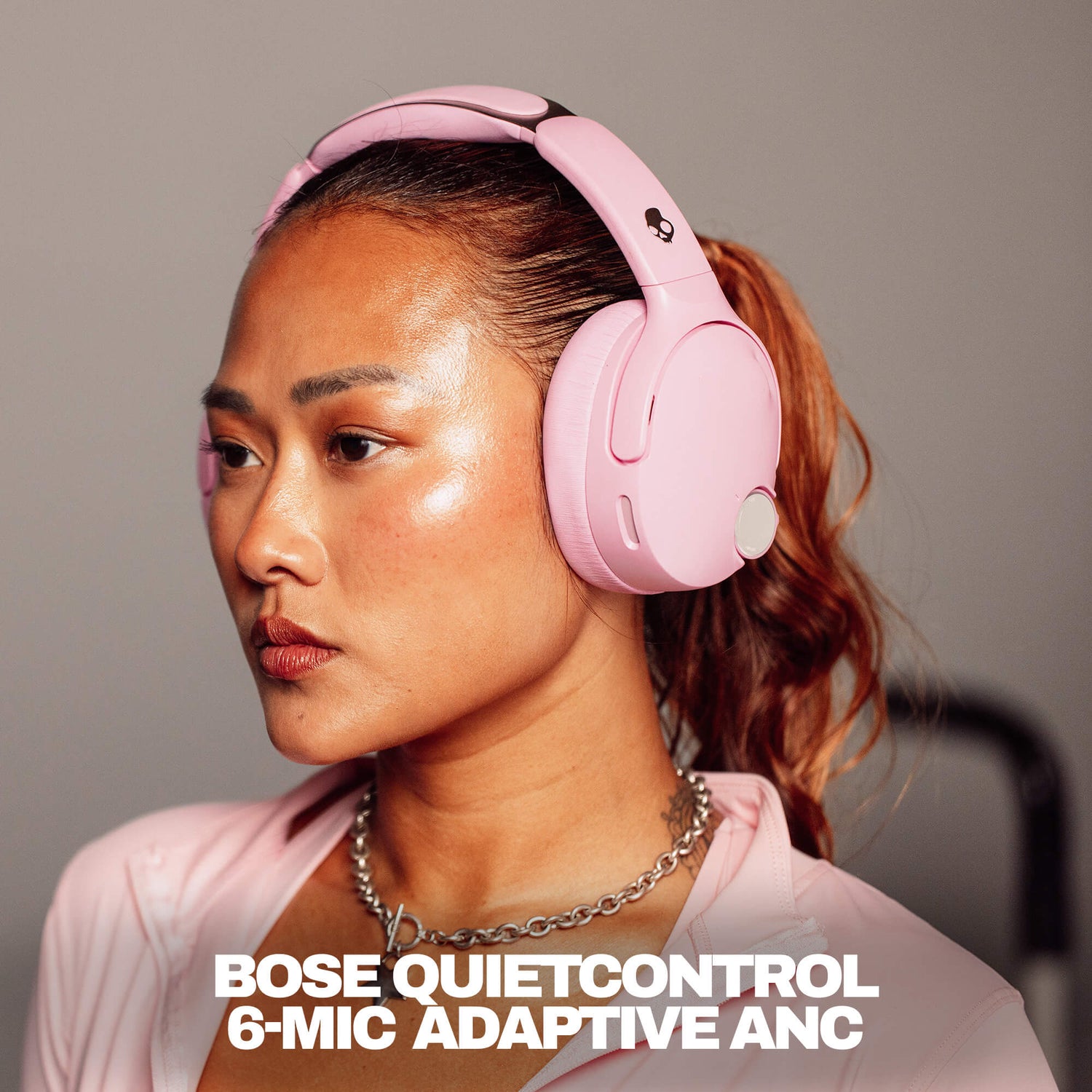 Woman wearing pink Bose QuietControl headphones with text overlay. | Candy