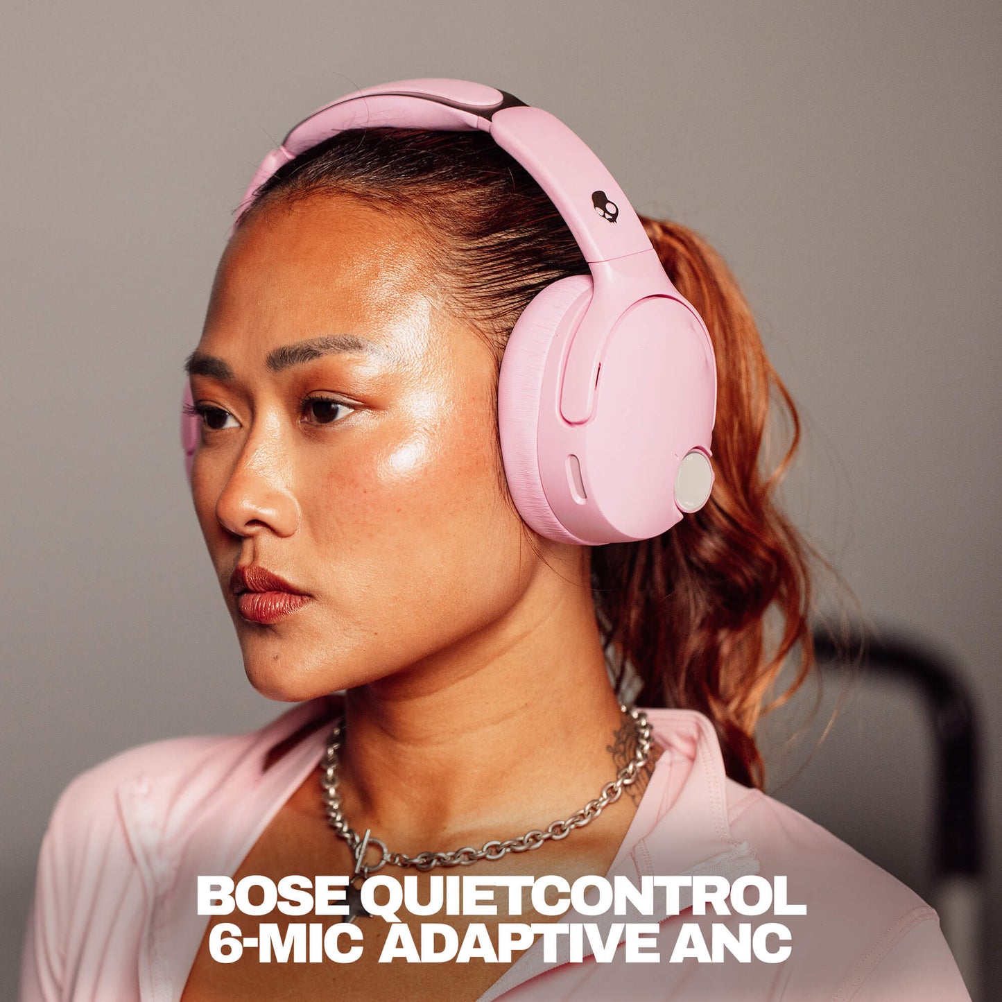 Woman wearing pink Bose QuietControl headphones with text overlay. | Candy