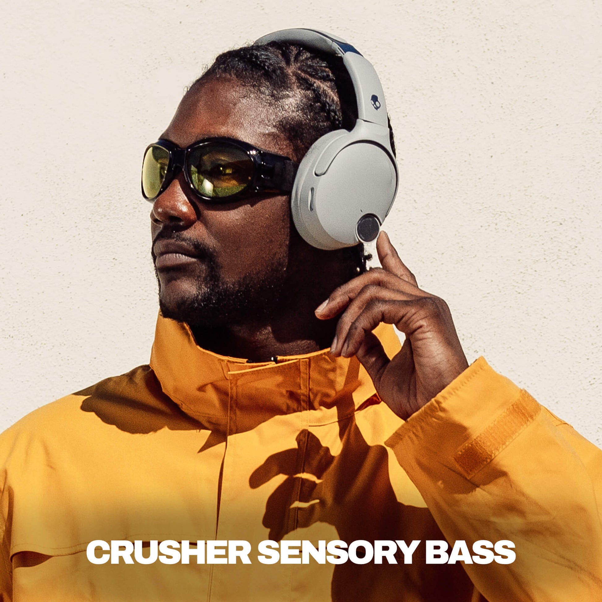 Man wearing headphones and sunglasses with a text overlay on a plain background | Cement