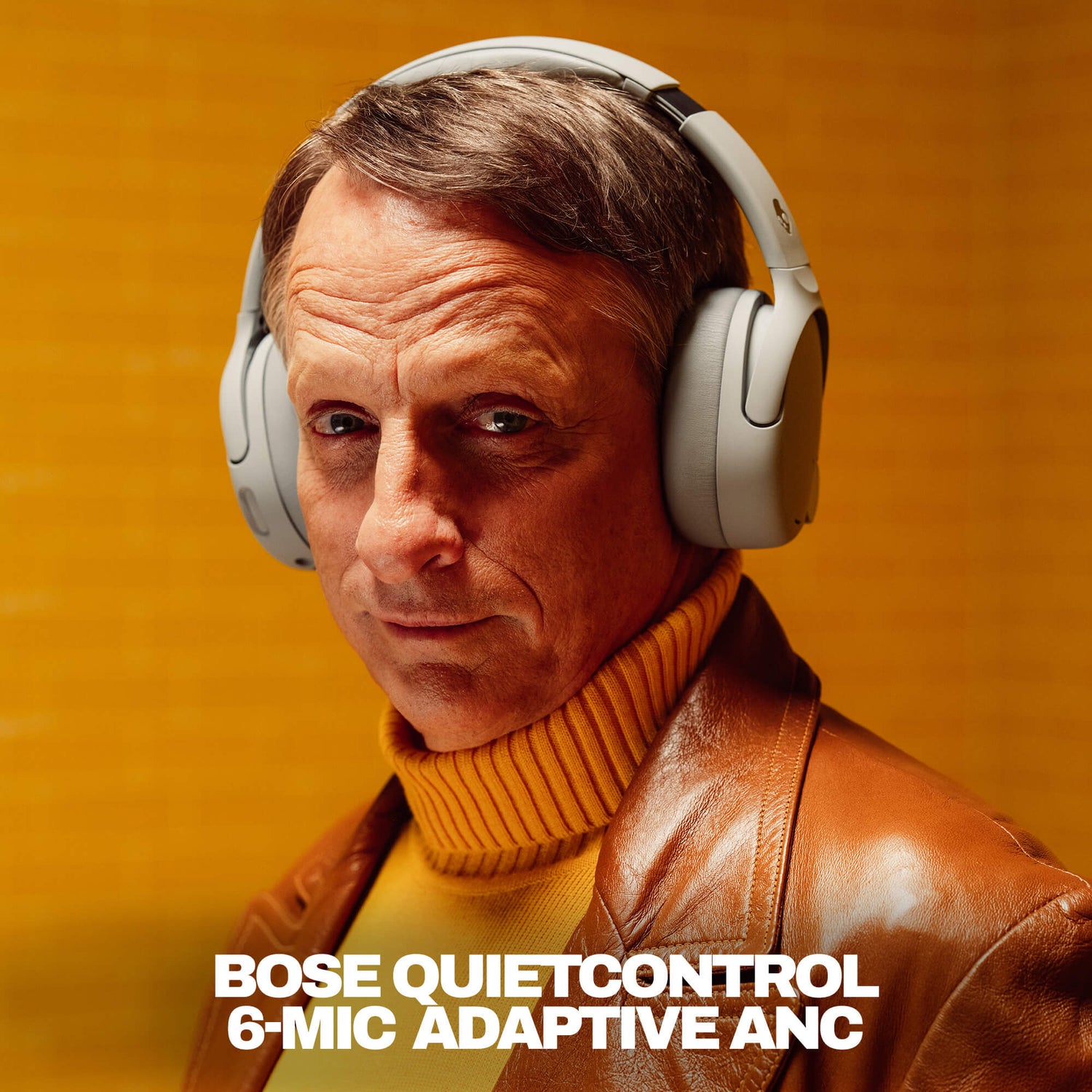 Tony Hawk wearing Bose QuietControl headphones with a warm background | Cement