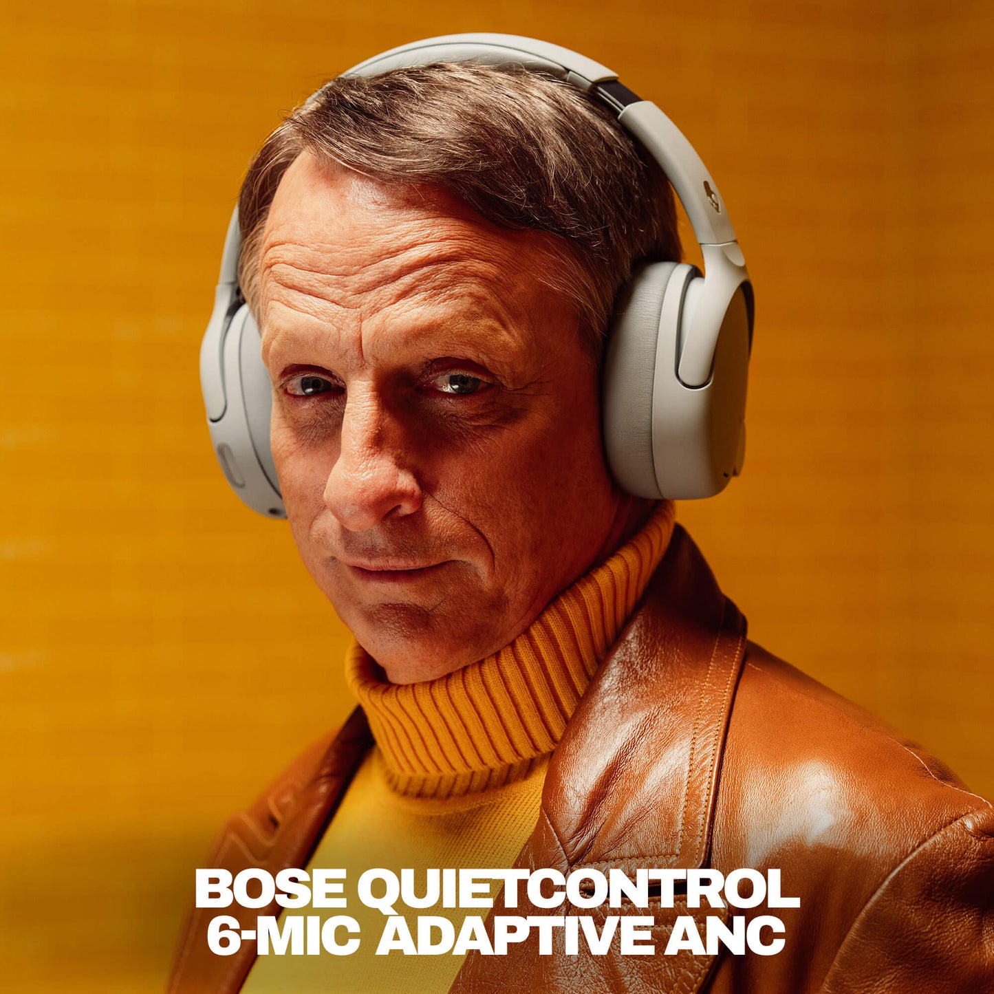 Tony Hawk wearing Bose QuietControl headphones with a warm background | Cement