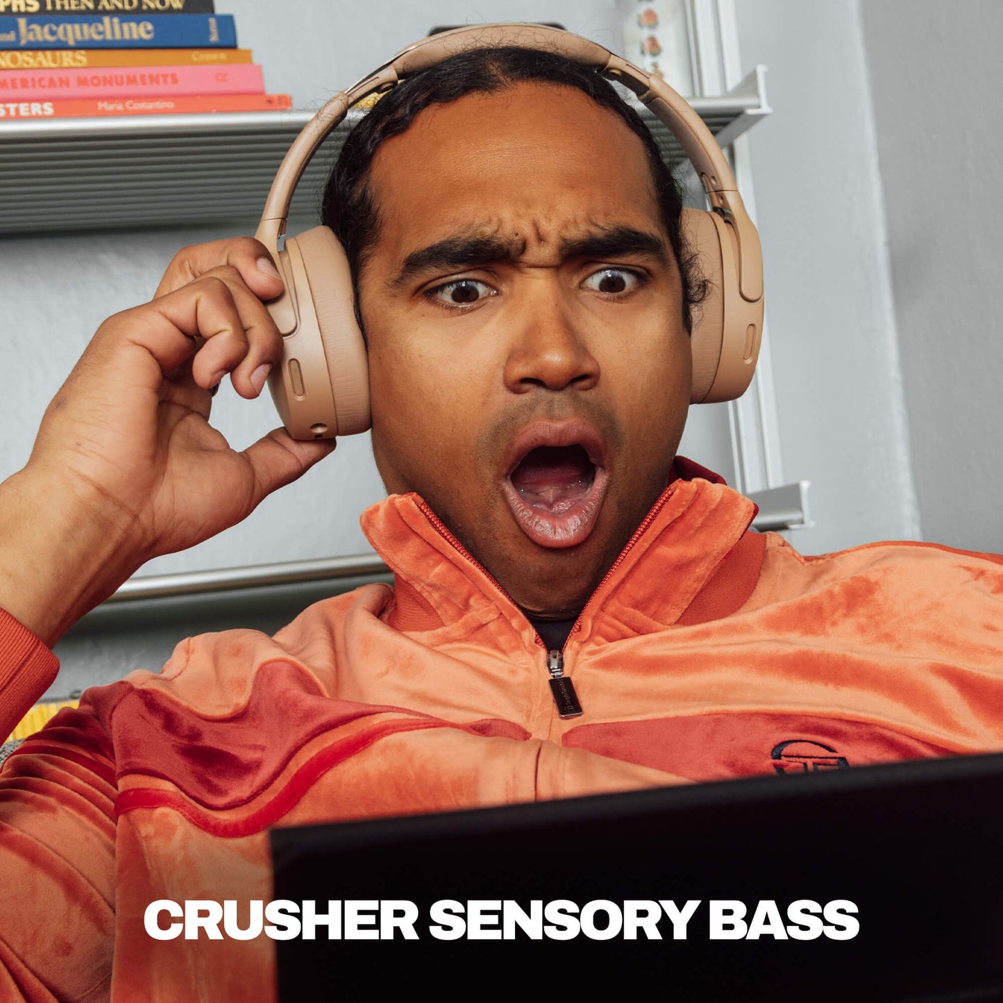 Person wearing headphones with a surprised expression, sitting in front of a laptop with 'Crusher Sensory Bass' text. | Primer