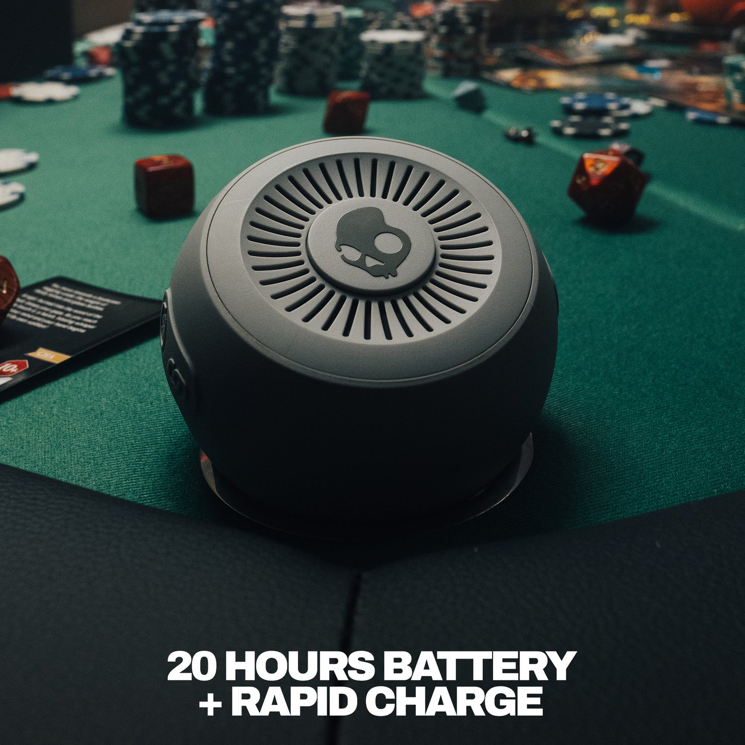 Round speaker on a gaming table with text about battery life and charging. | Cement