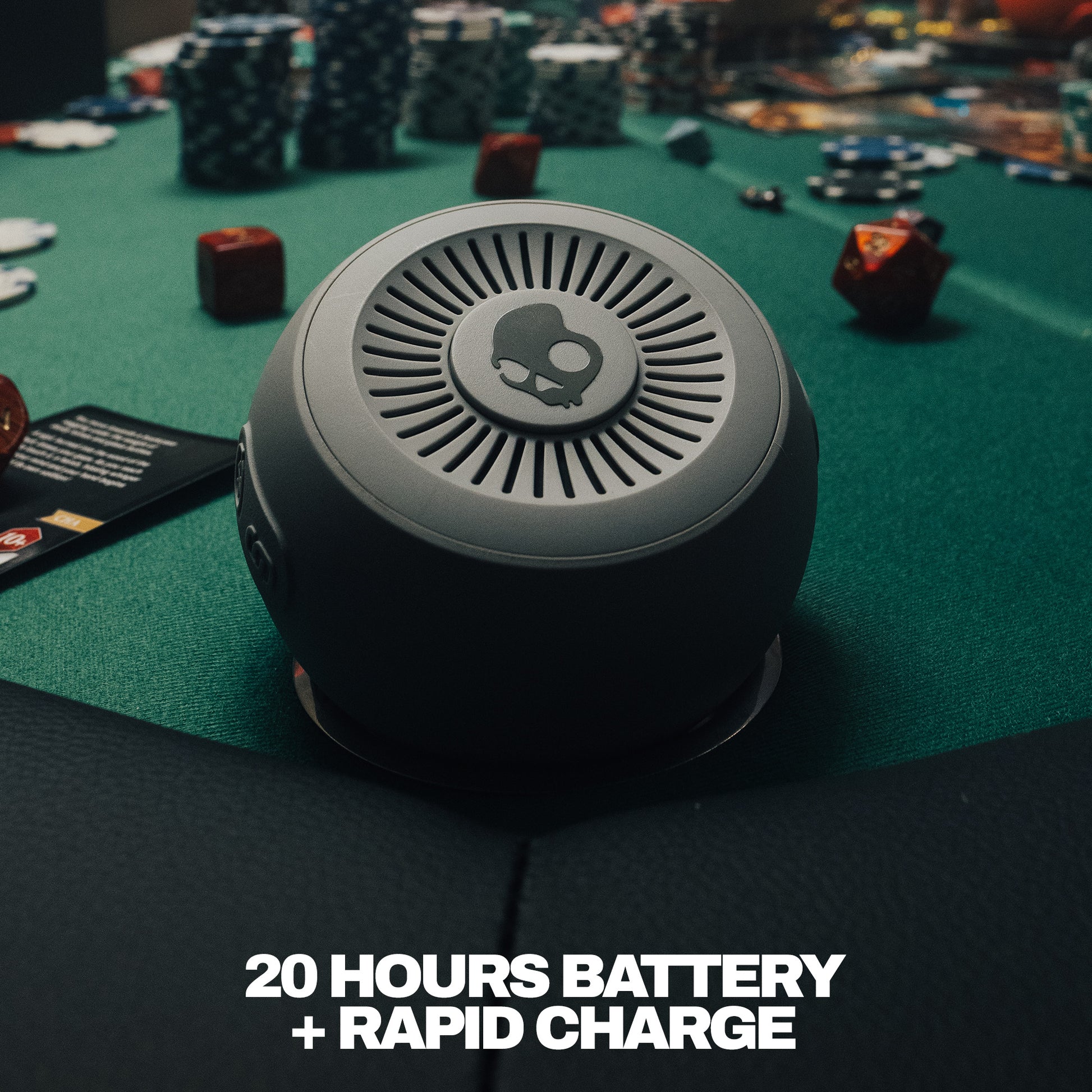 Round speaker on a gaming table with text about battery life and charging. | Cement