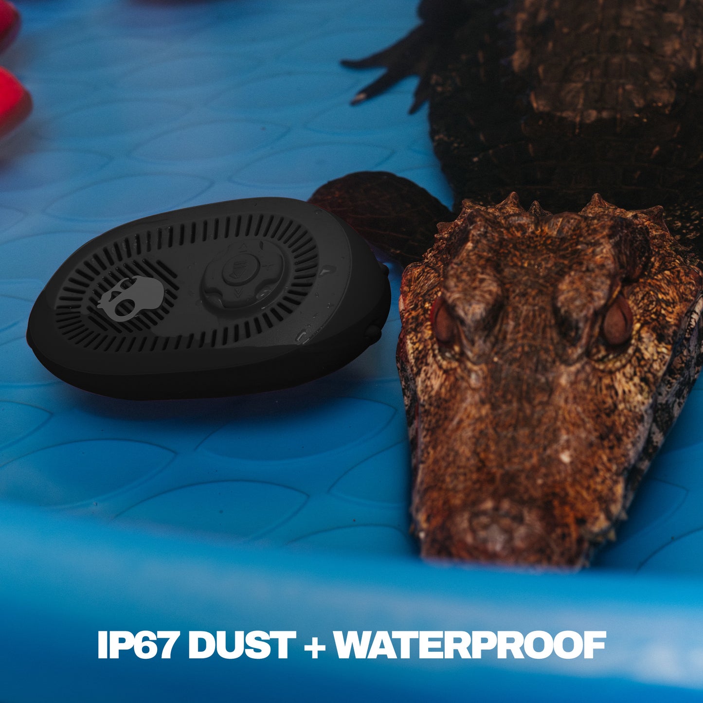 Black waterproof Speaker on a blue surface with text 'IP67 DUST +  WATERPROOF'. | True Black