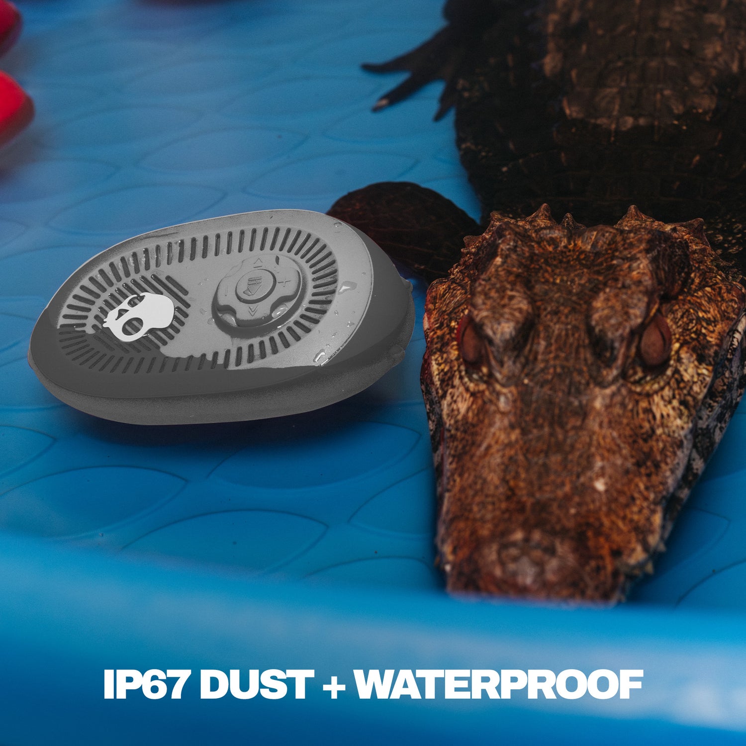 Gray speaker on a blue surface with an octopus in the background, featuring IP67 dust and waterproof text. | Cement