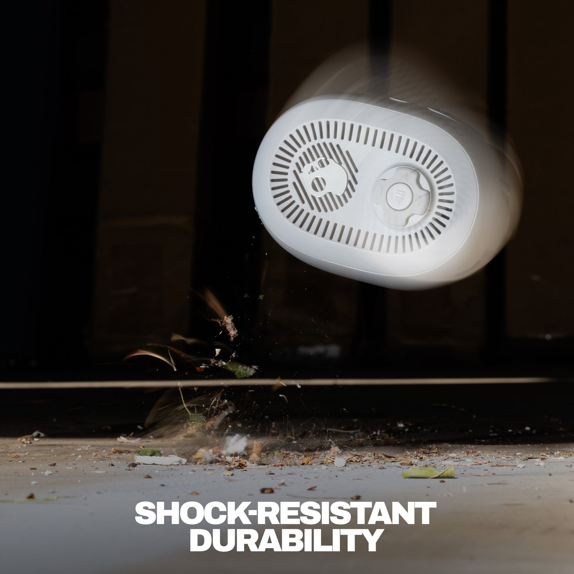 Close-up of speaker with text 'Shock-Resistant Durability' on a dark background | Cement
