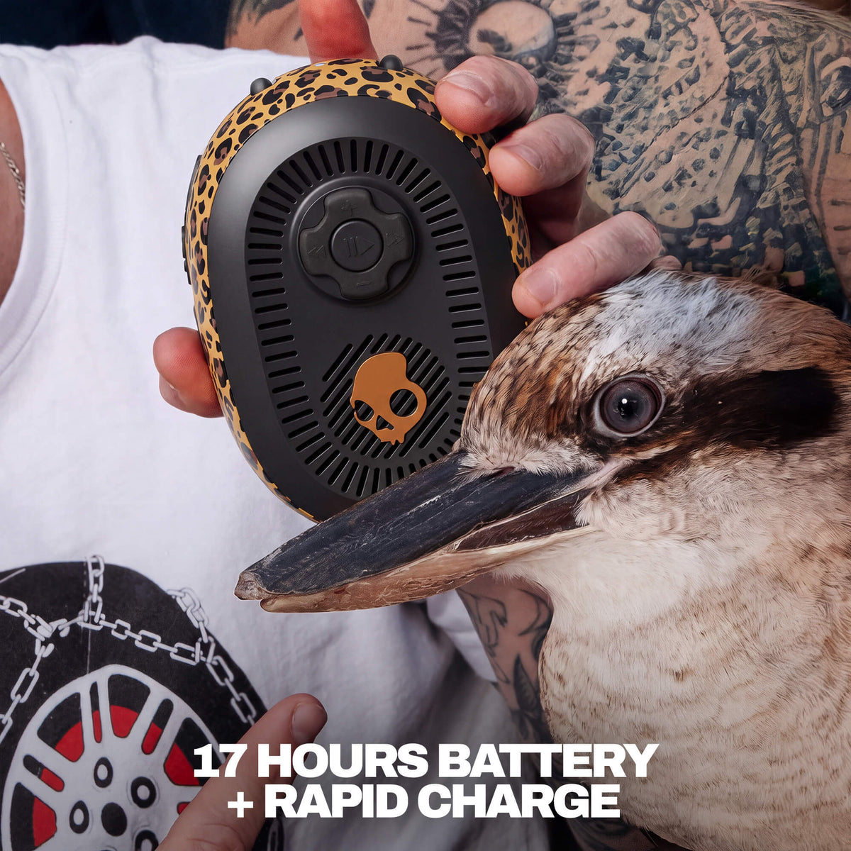 A person holds a leopard-print and black portable session 540 speaker with a kookaboo in the foreground. White text at the bottom reads '17 HOURS BATTERY + RAPID CHARGE'. | Leopard