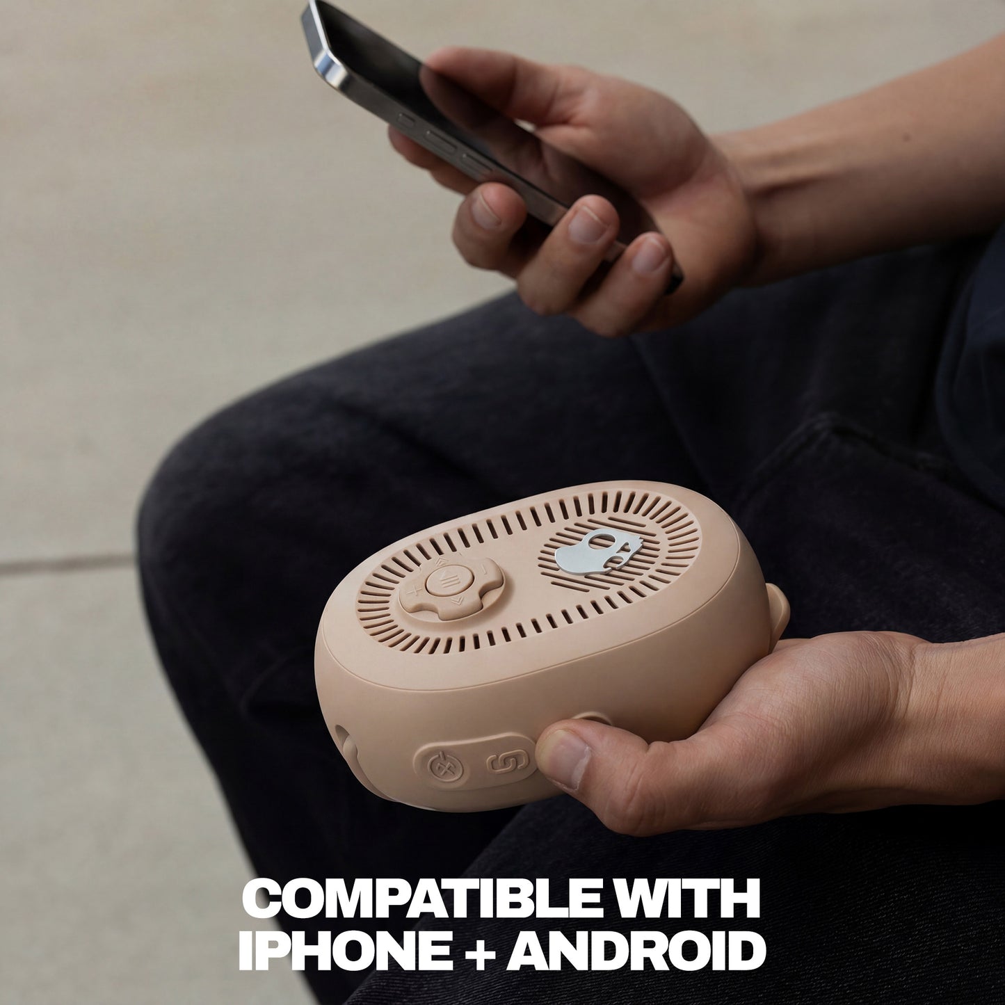 Person holding a beige portable speaker and a smartphone, with text indicating compatibility with iPhone and Android. | Primer