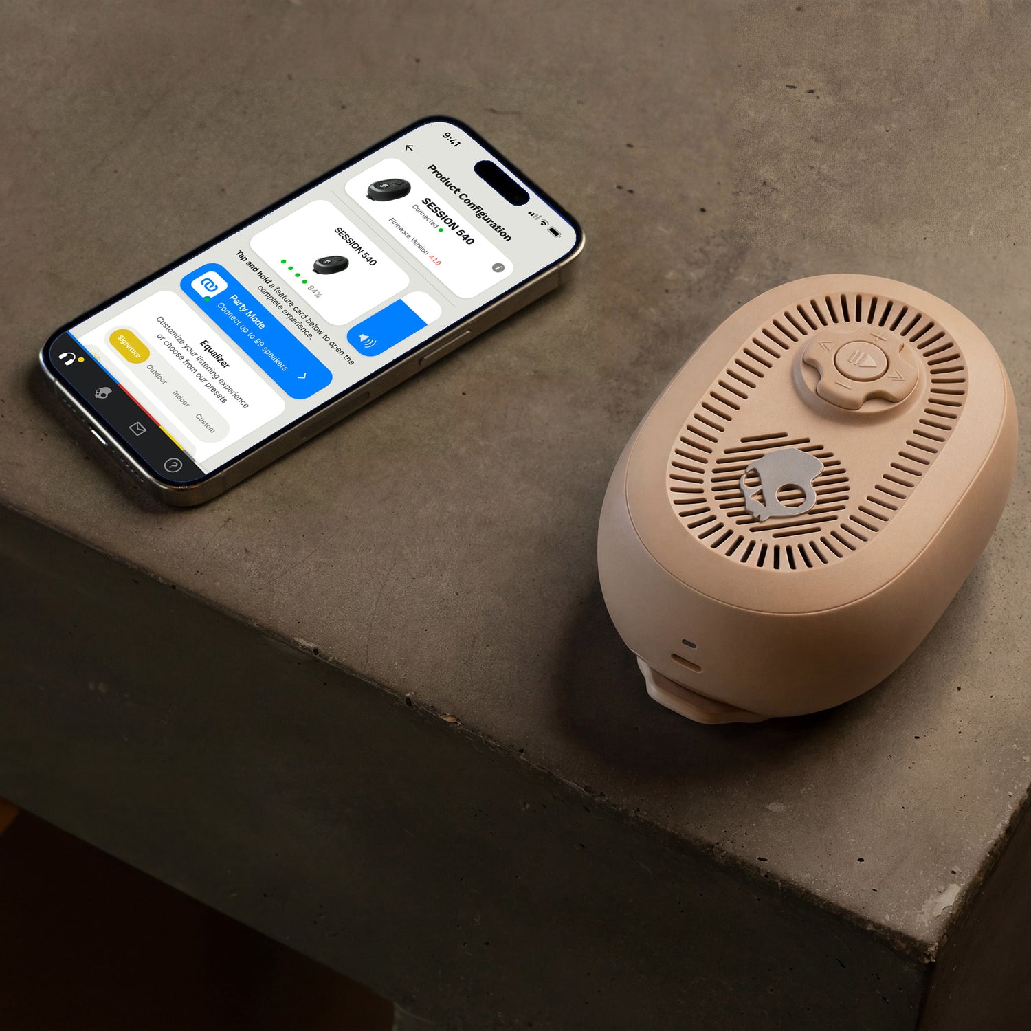 Smart device with app interface next to a cylindrical beige speaker on a concrete surface | Primer