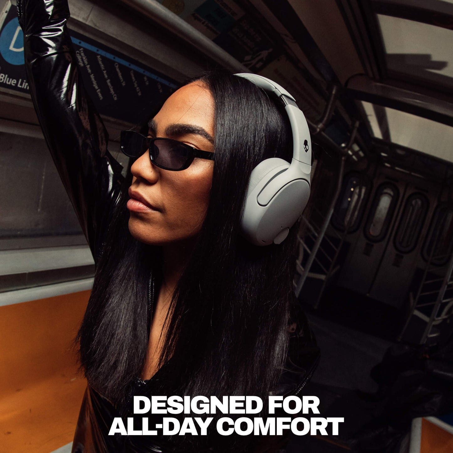 Person wearing Crusher 720 headphones and sunglasses inside a vehicle with text 'DESIGNED FOR ALL-DAY COMFORT'. | Cement