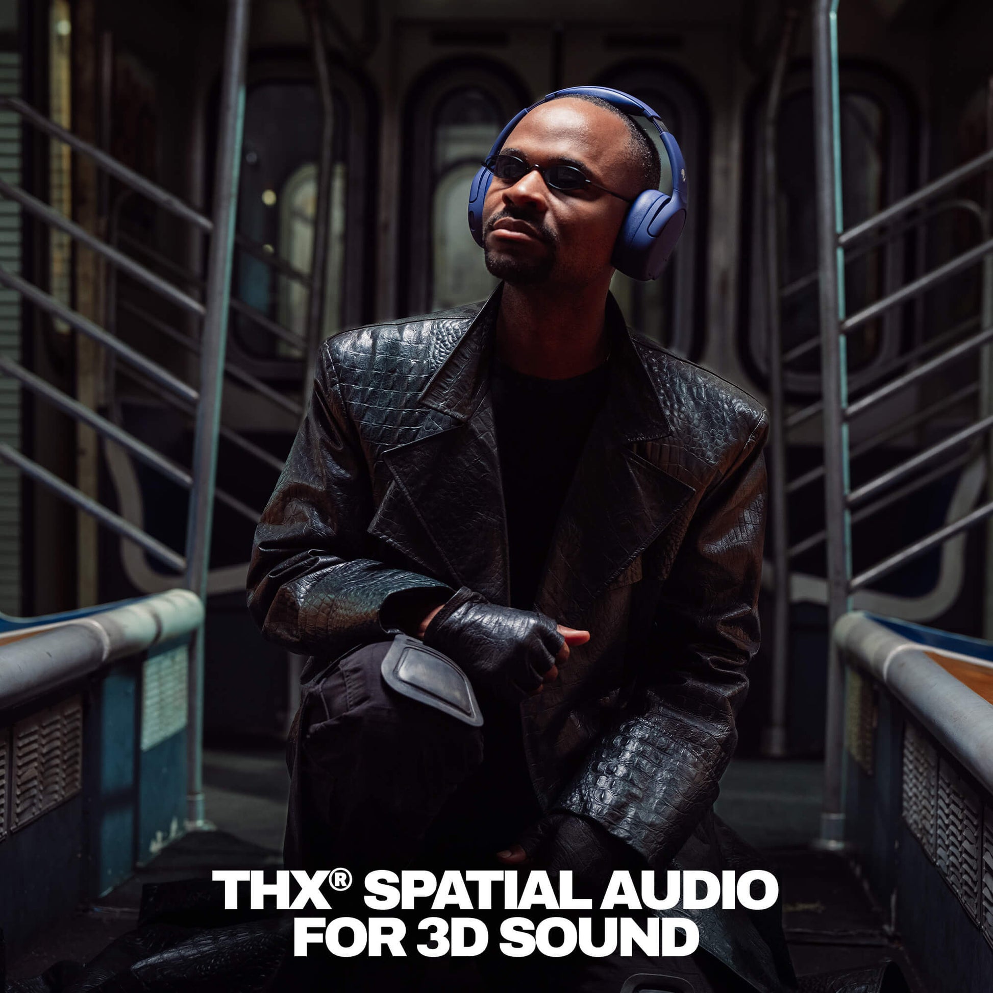 Person wearing Crusher 720 headphones and a dark coat in a futuristic setting with 'THX Spatial Audio' branding. | Future