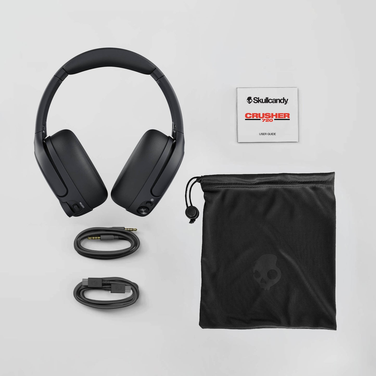 Skullcandy Crusher 720 headphones with accessories on a light gray background | Plasma
