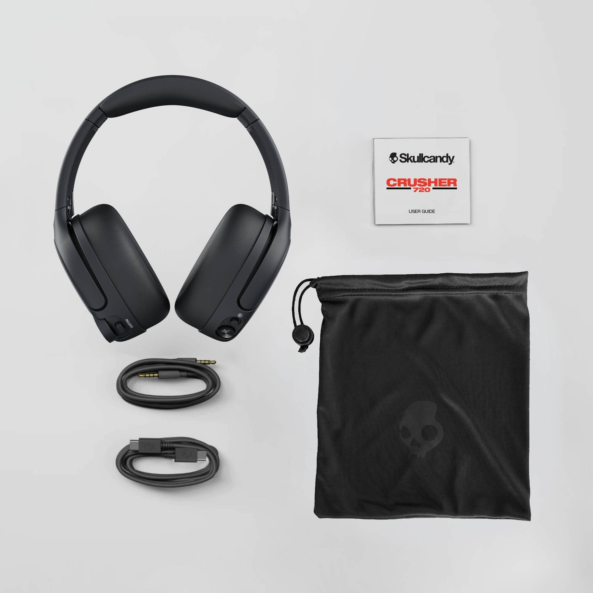 Skullcandy Crusher 720 headphones with accessories on a light gray background | Plasma
