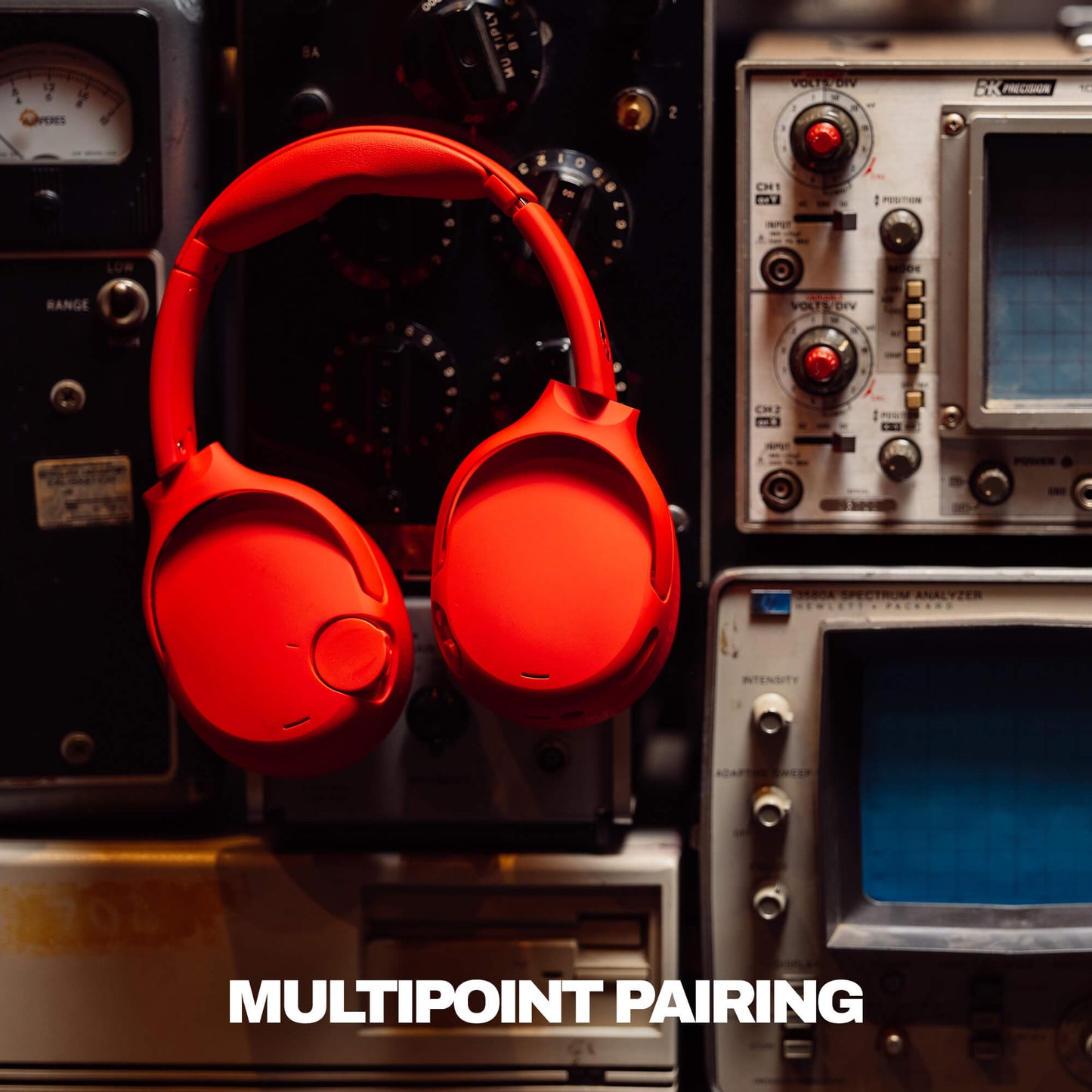Red Crusher 720 headphones on a vintage electronic equipment background with 'MULTIPOINT PAIRING' text. | Plasma